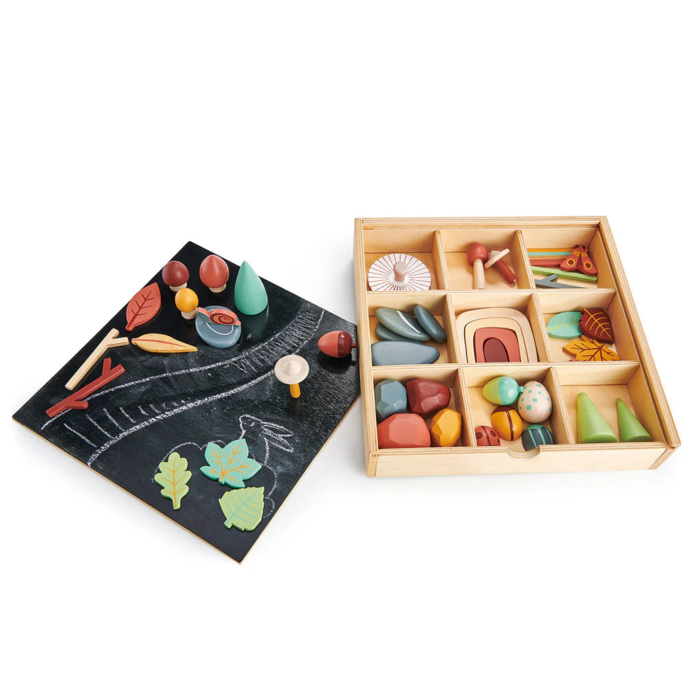 Colorful wooden toys in a box with a chalkboard and toys on it, featuring Junior Design Awards 2021 silver badge.