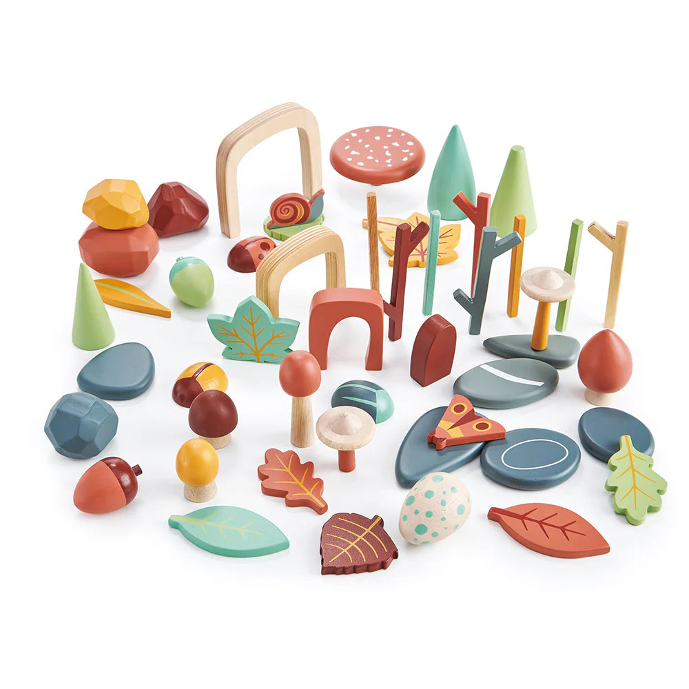 Assorted wooden toys including trees, rocks, and animals on a white background