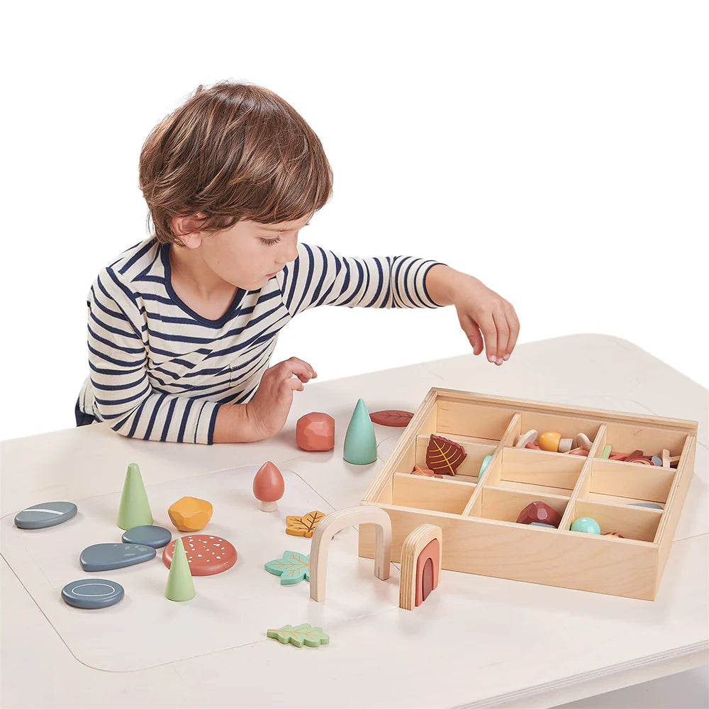 Child playing with wooden toys on a table