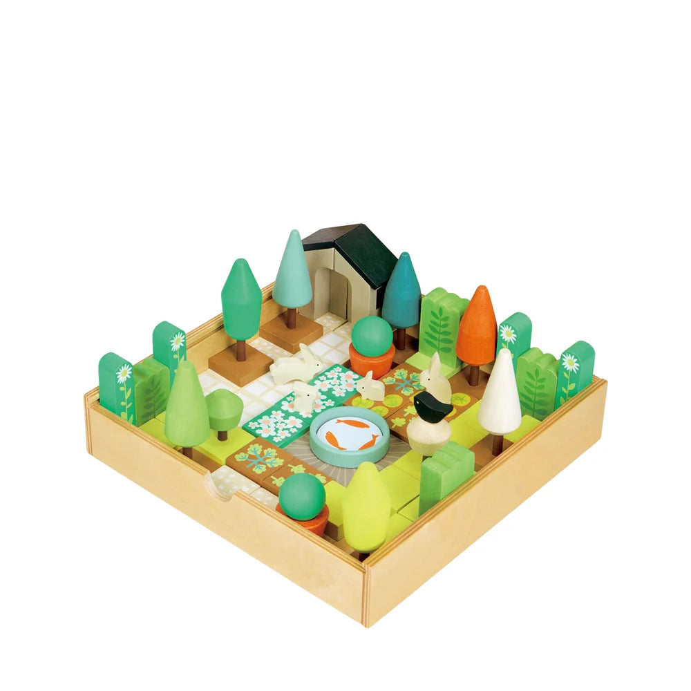 Wooden toy garden set with trees, house, and animals on a white background