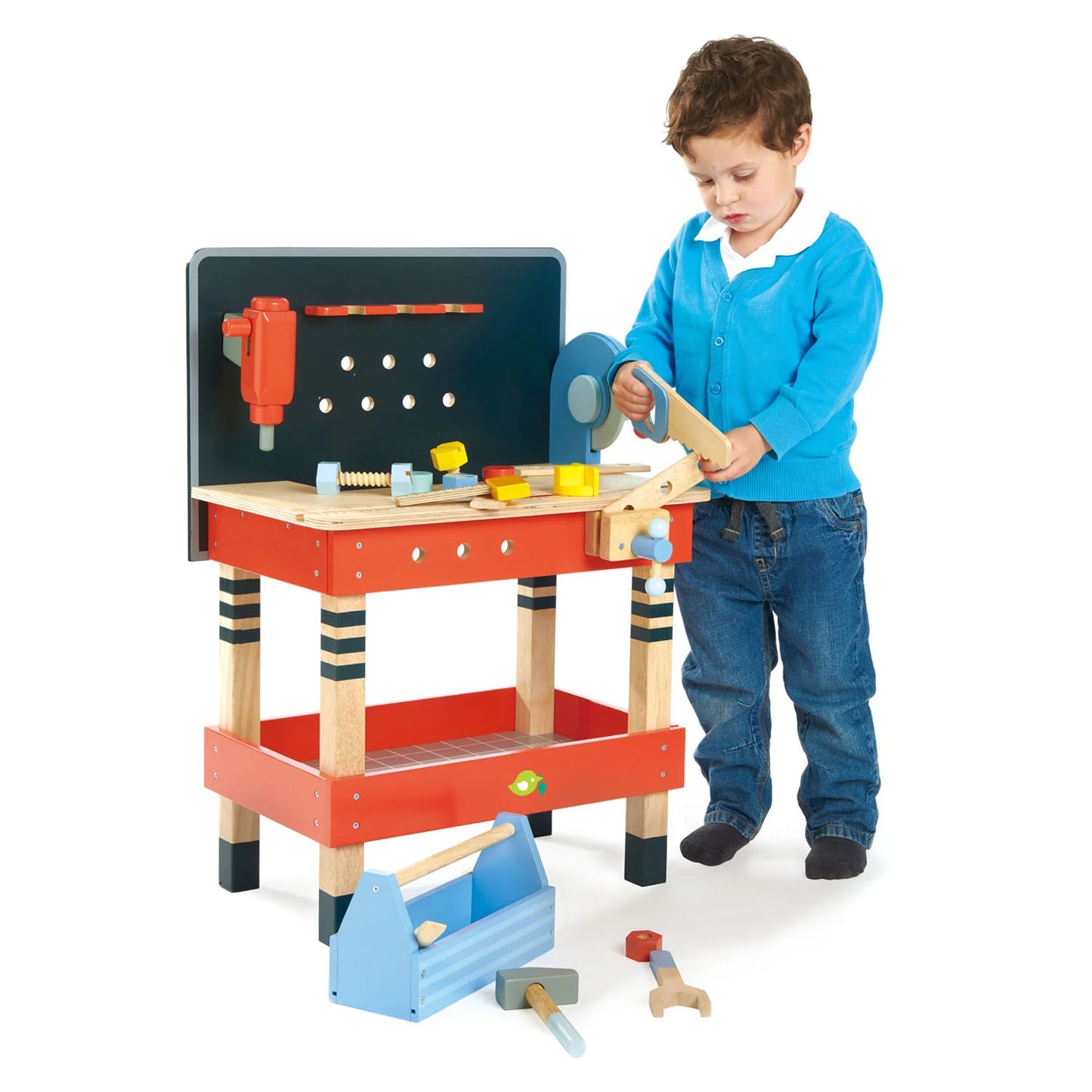 Child playing with a toy workbench and tools on a white background