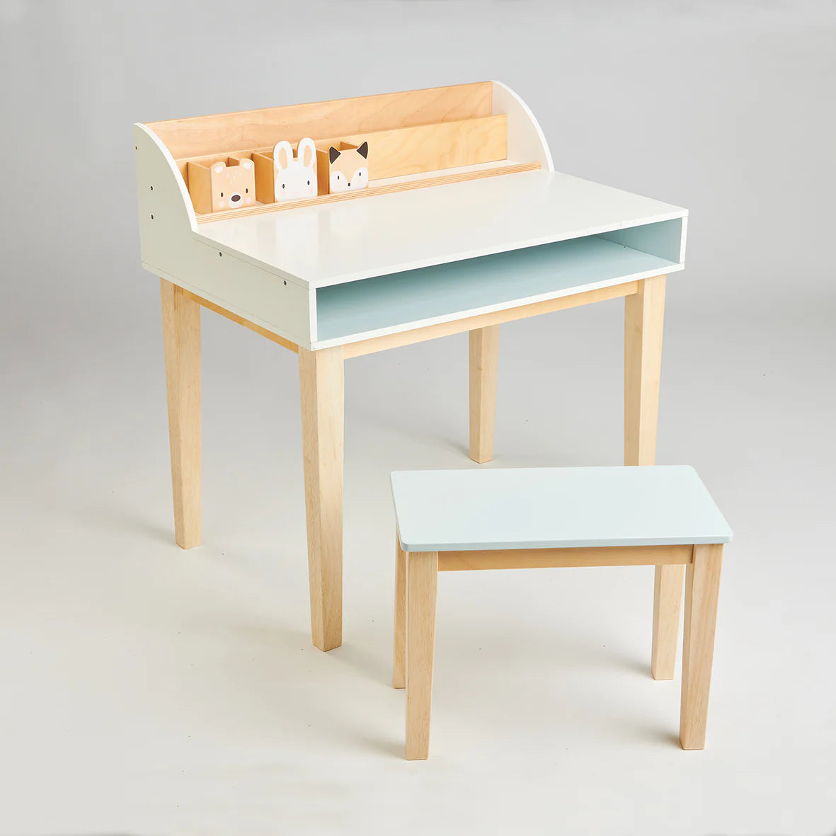 Children's desk with a light blue shelf and white top, accompanied by a matching stool on a gray background.