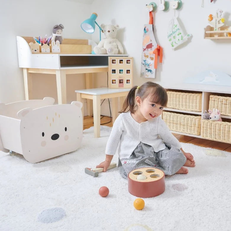 Child playing with toys in a room with furniture and decor