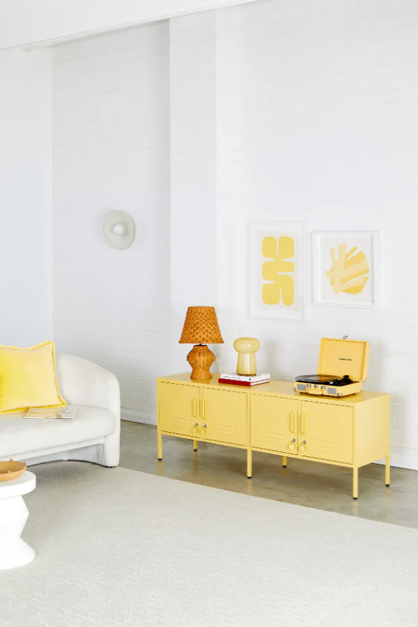 Yellow sideboard in a living room with decor items
