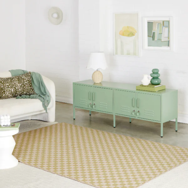 Living room with a green cabinet, white sofa, and decorative items.