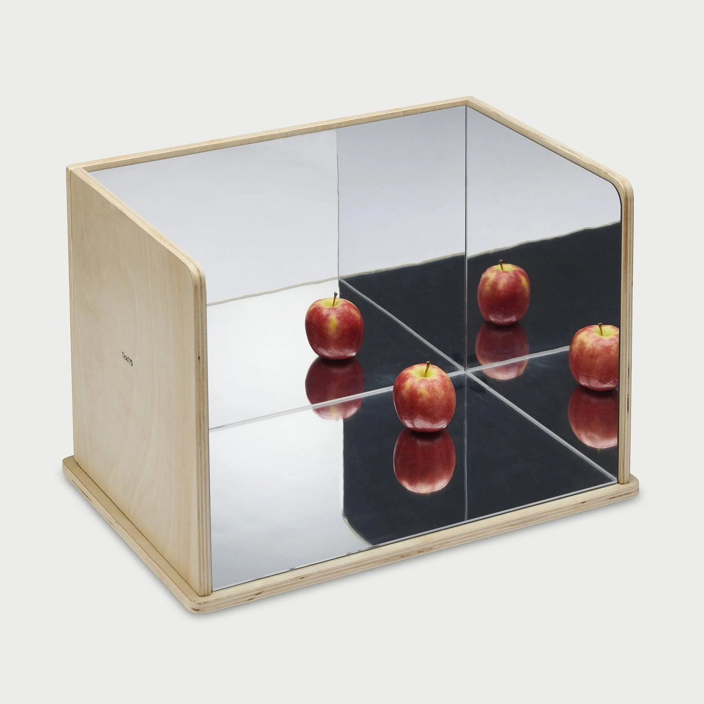 Wooden Exploratory mirror with an apple reflecting over the surfaces