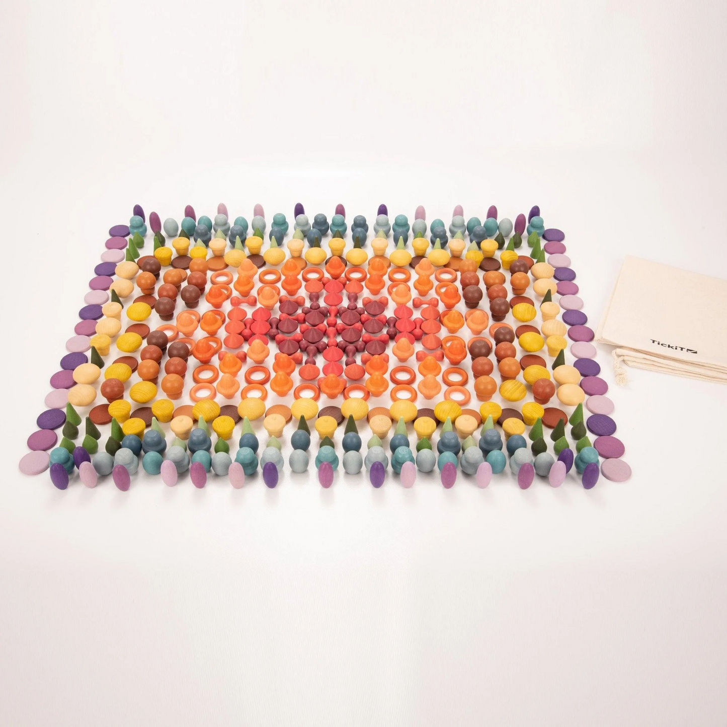 Colourful wooden loose parts lined in colour sets