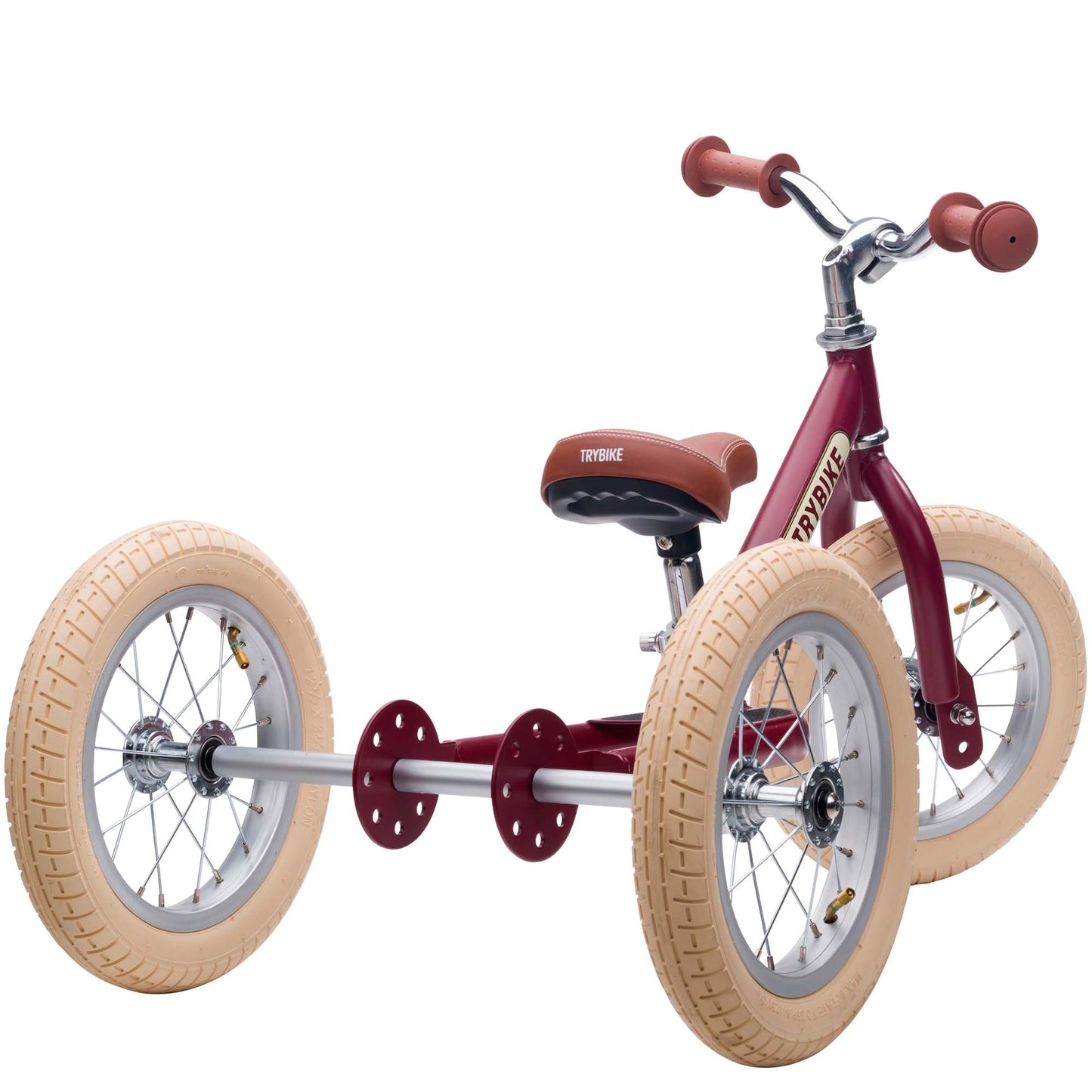 Red tricycle with tan tires on a white background