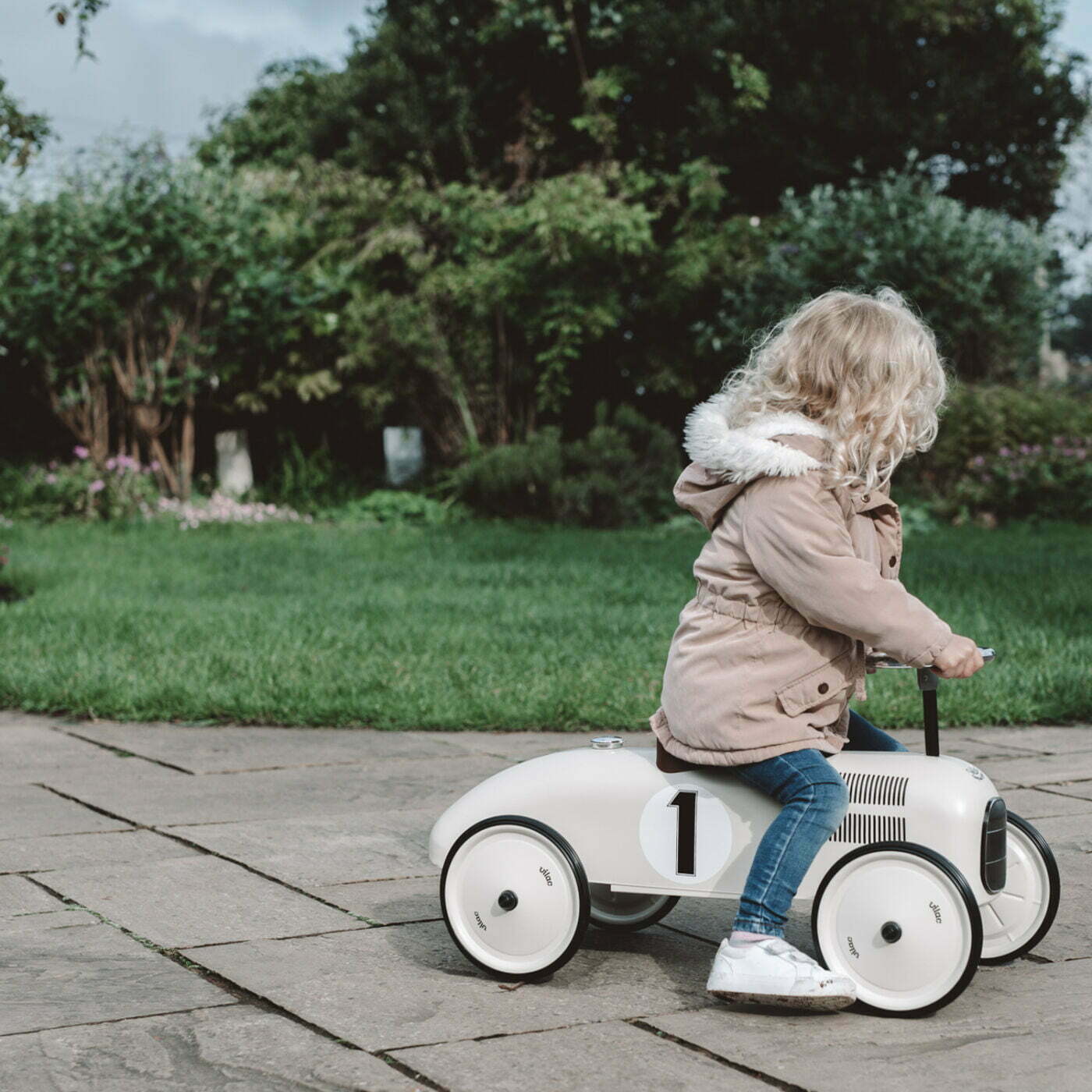 Ride on car with number 1 on the side with child riding on it