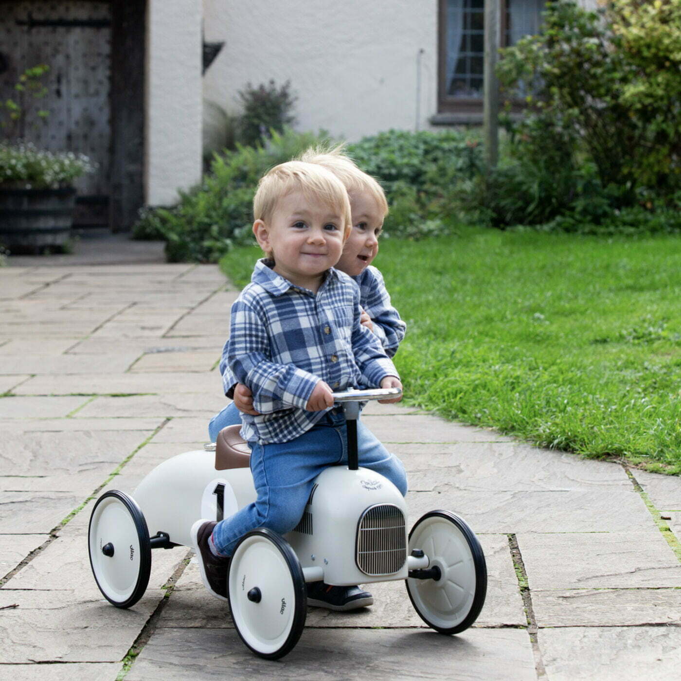 Ride on car with number 1 on the side with children riding on it