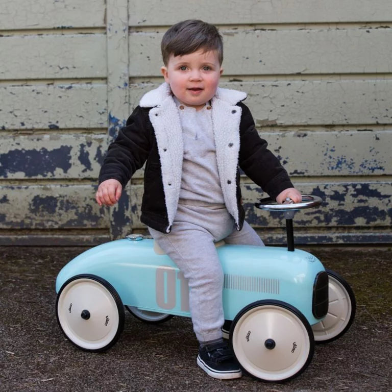 Children's toy car with number 01 with child riding on it