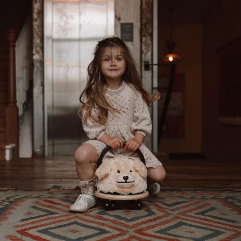 Child sat on plush dog ride on toy