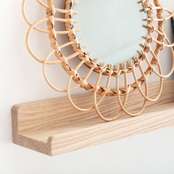 Wooden necklace on a wooden stand against a light background