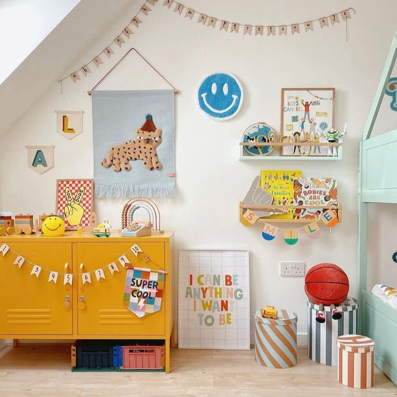 Children's room with colorful furniture, toys, and wall decorations.