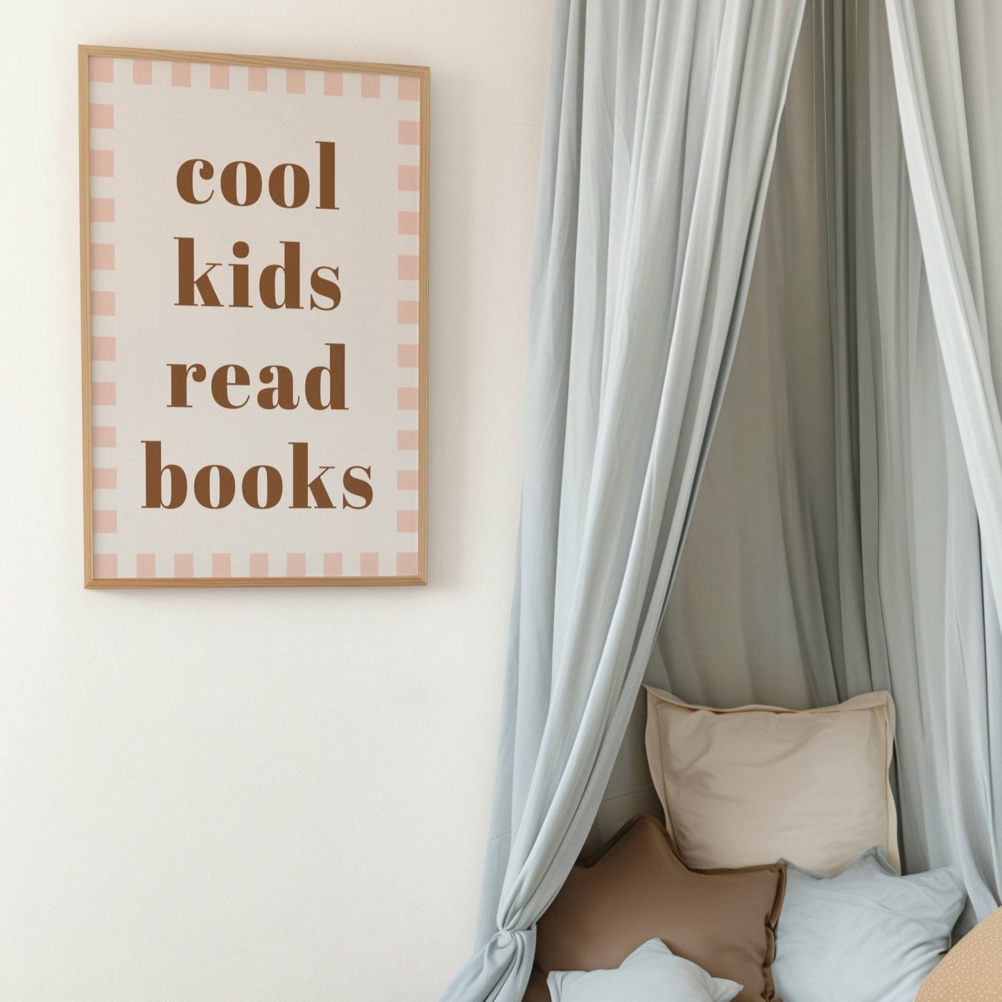 Children's reading nook with a framed sign, teddy bear, and cushions.