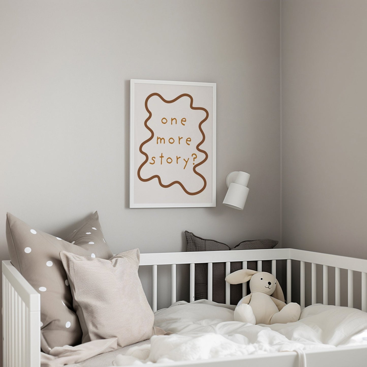 Children's bedroom with a crib, pillows, and a framed picture on the wall.