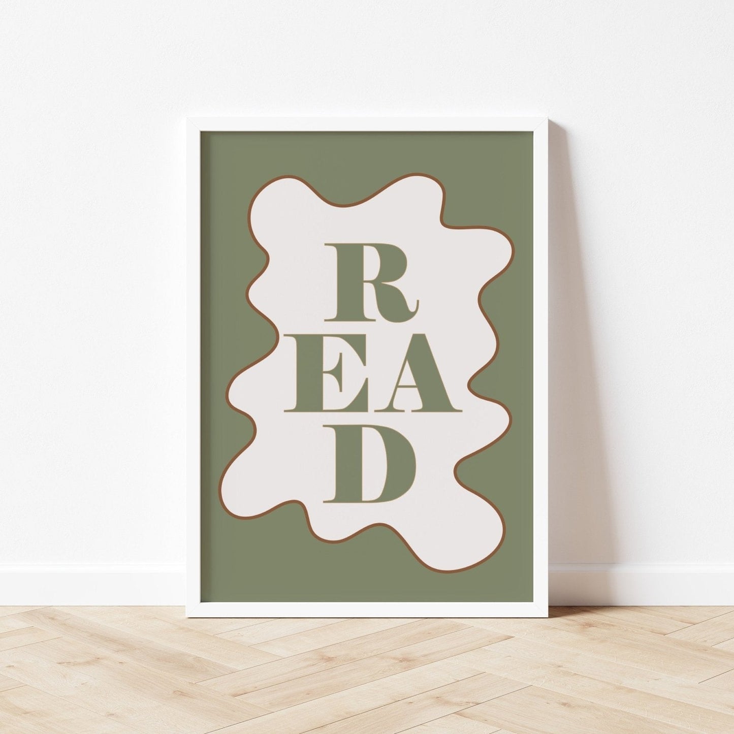 Sage green book with 'READ' design on a white surface