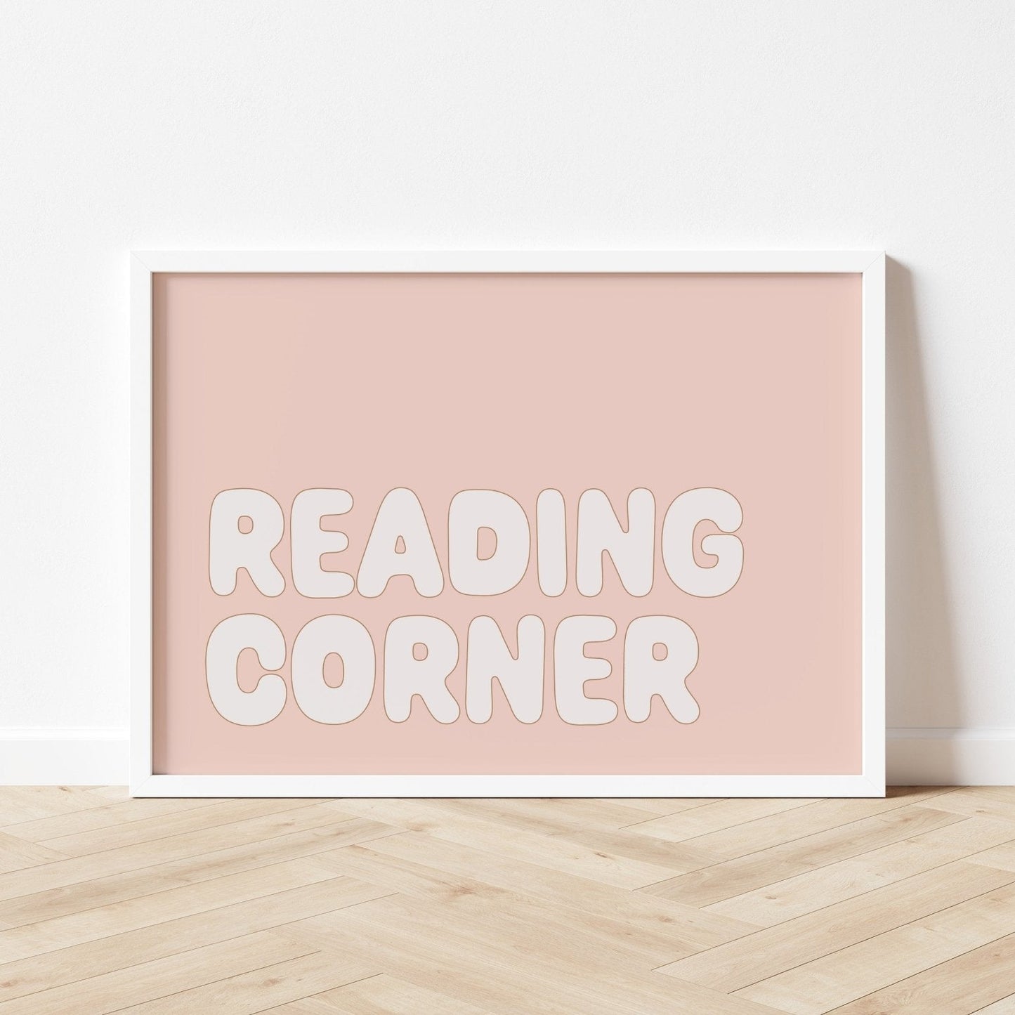 Framed poster with 'READING CORNER' text on a pink background