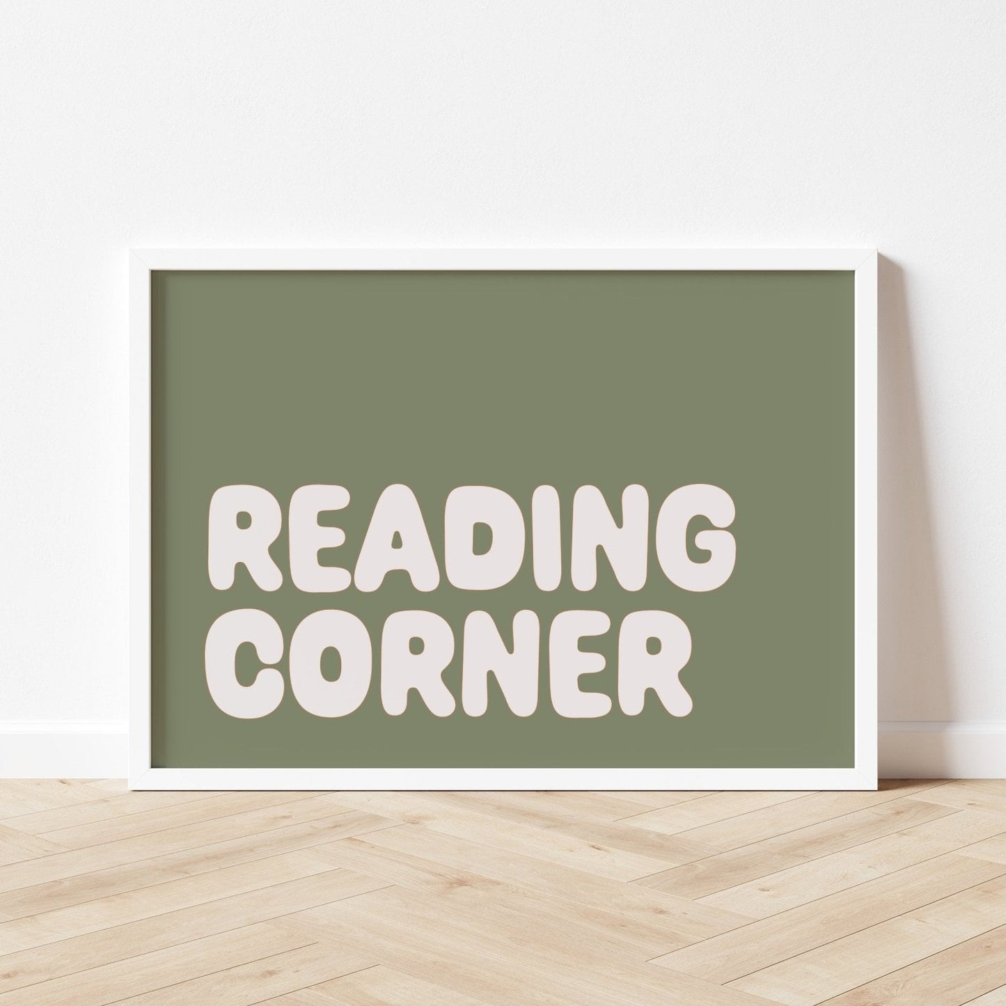 Framed sign with 'READING CORNER' text on a white wall.