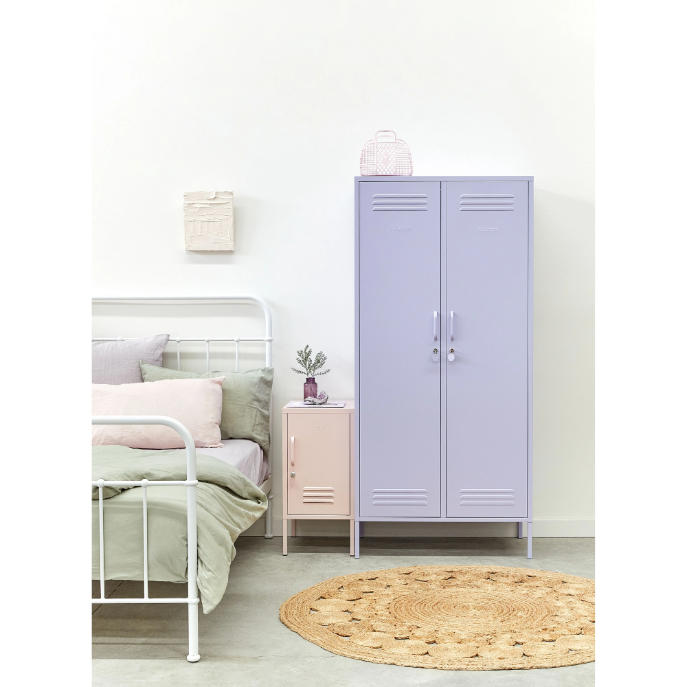 Room interior with a bed, nightstand, and purple locker.