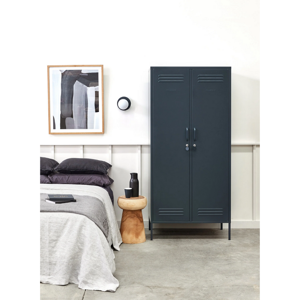 Navy blue locker in a bedroom with bed and wall art