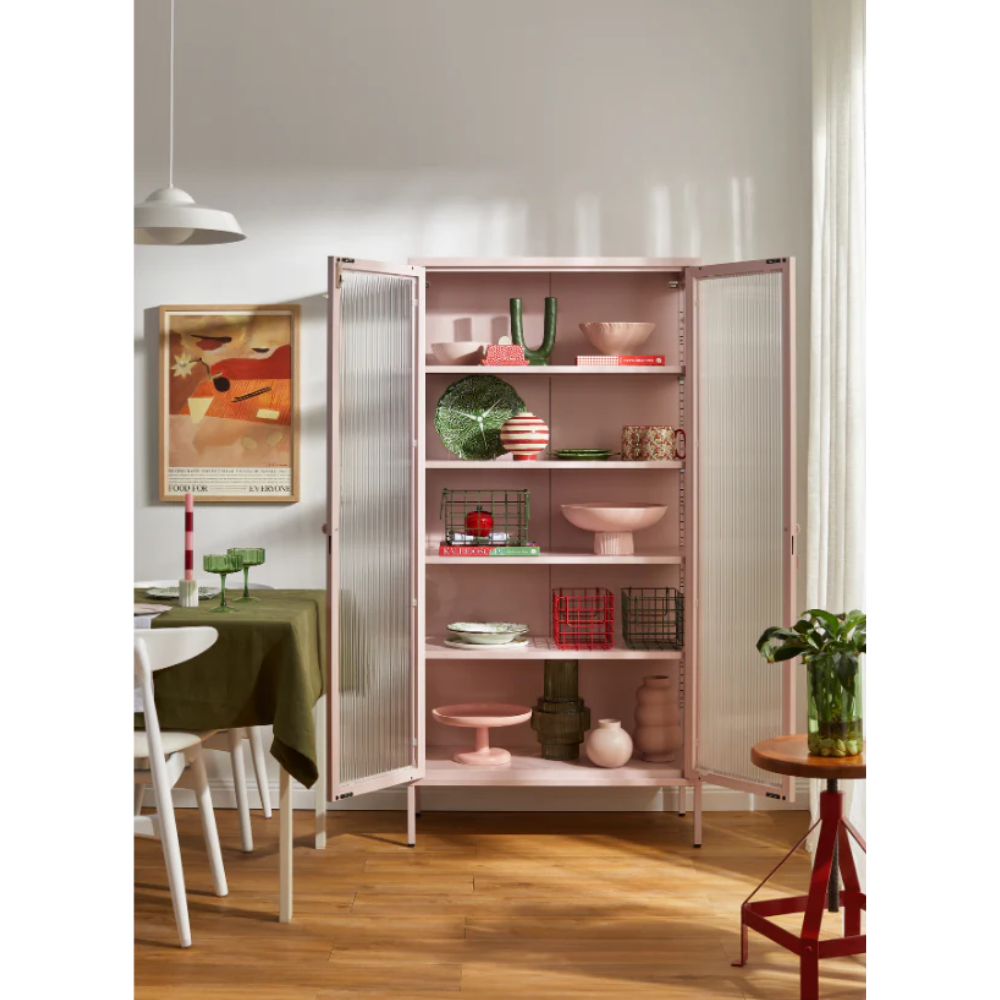 Pink cabinet with the door open in a dining room