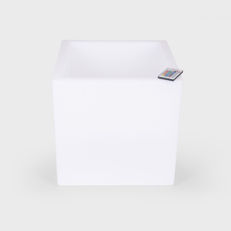 White LED light cube with remote control on a white background