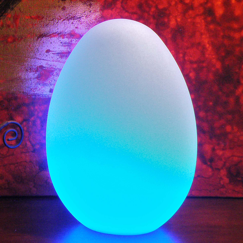 Glowing blue egg-shaped light on a textured red and purple background