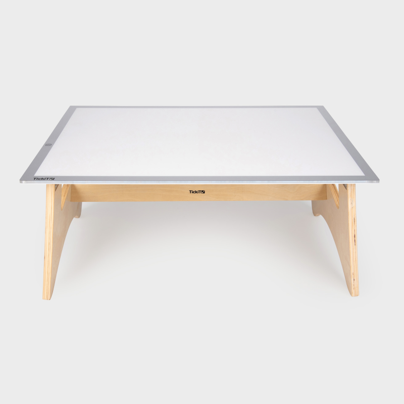 Rectangular table with a light panel on top and wooden legs on a white background