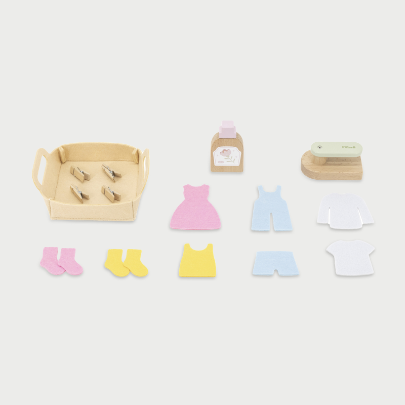 Set of wooden toys including a box, bottles, and clothing items on a white background
