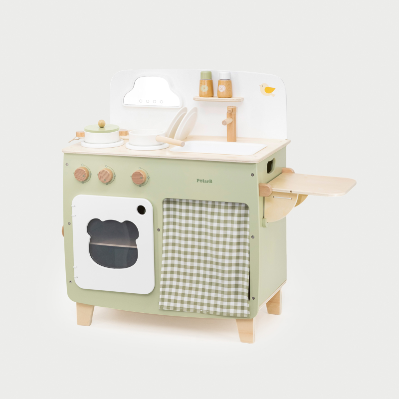 Children's play kitchen set with green oven and white countertop on a light gray background