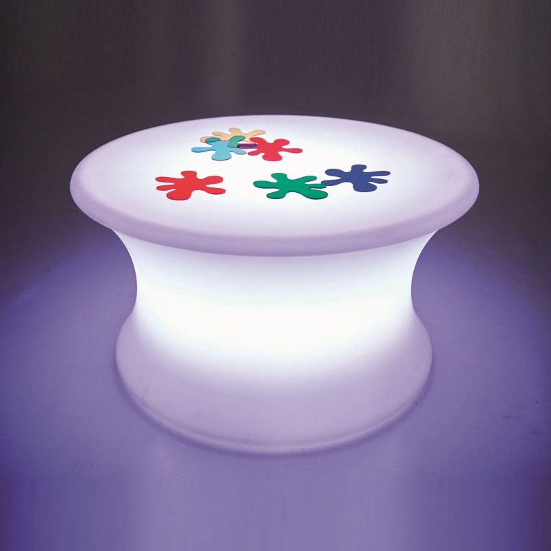 Colorful flower designs on a glowing white table against a dark background