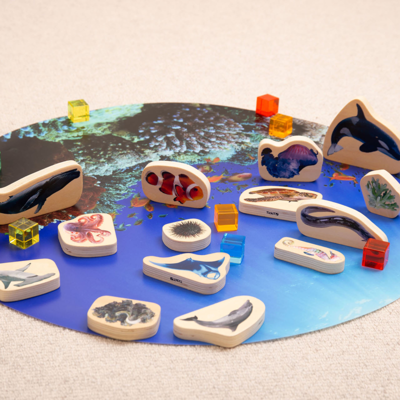 Wooden animal figures on a play mat