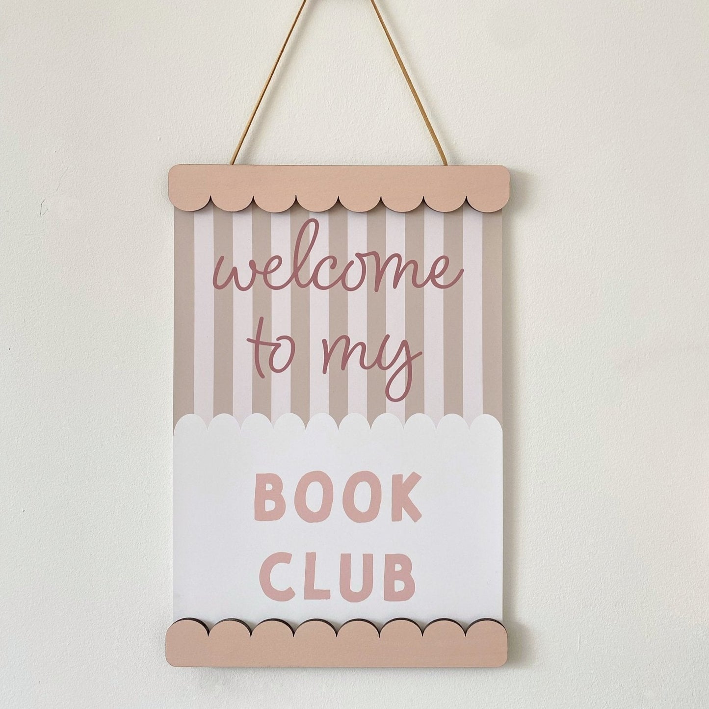 Decorative sign with 'welcome to my book club' text on a striped background