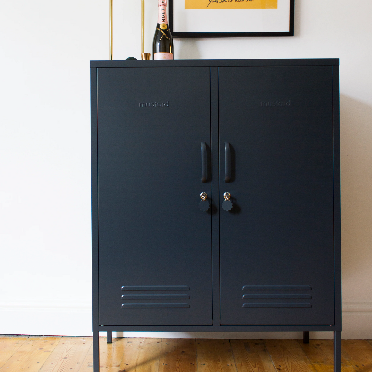 Navy blue cabinet with a framed 'LOVE' poster on a white wall.