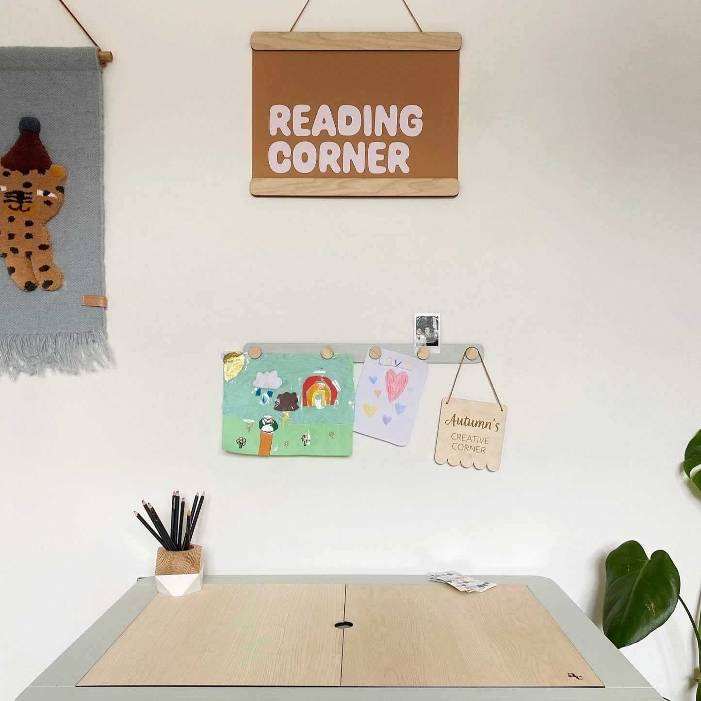 Children's play area with a table, wall decorations, and a 'Reading Corner' sign.