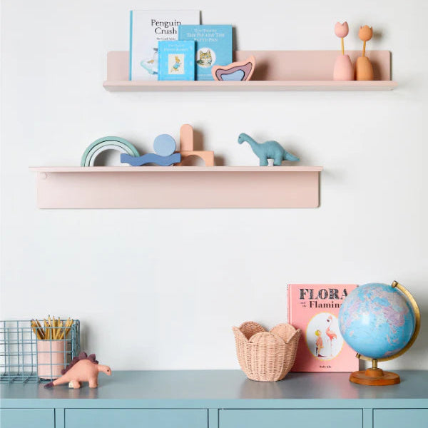 Children's room with shelves and cabinets, featuring toys and decor items.