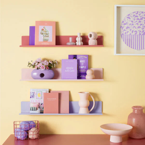 Shelves with decorative items against a yellow wall