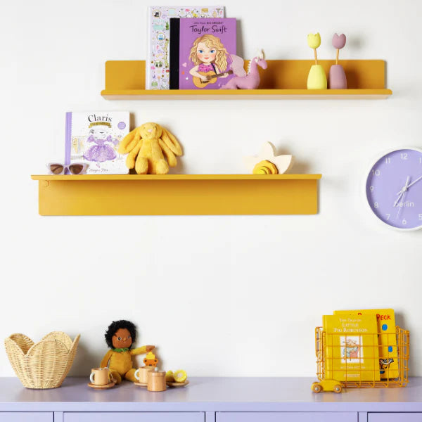Children's room with yellow shelves, toys, and a purple cabinet.