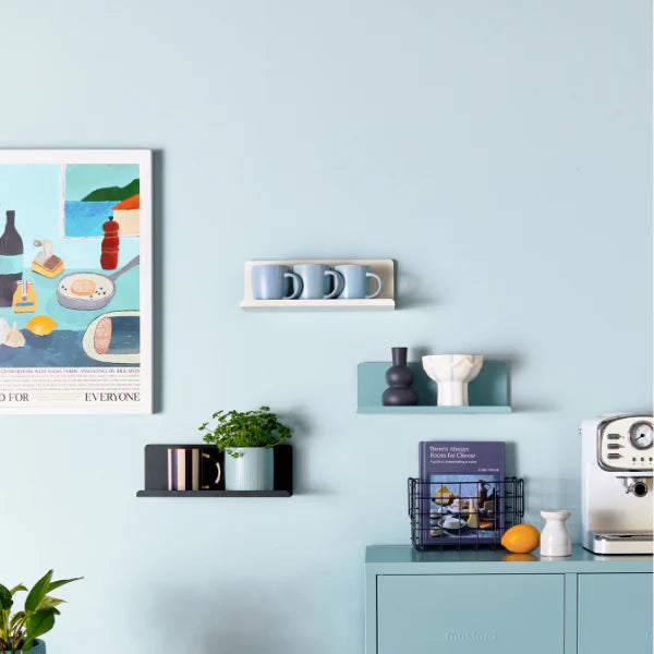 Kitchen interior with light blue walls, cabinets, and chairs.