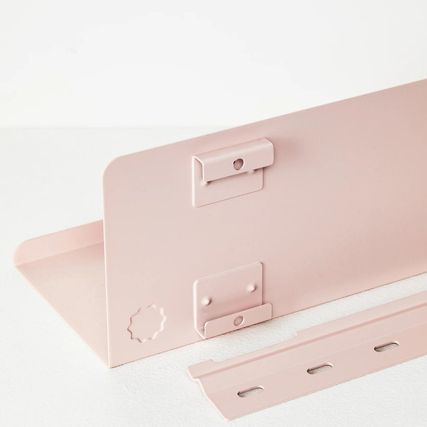 Pink metal bracket on a white background
