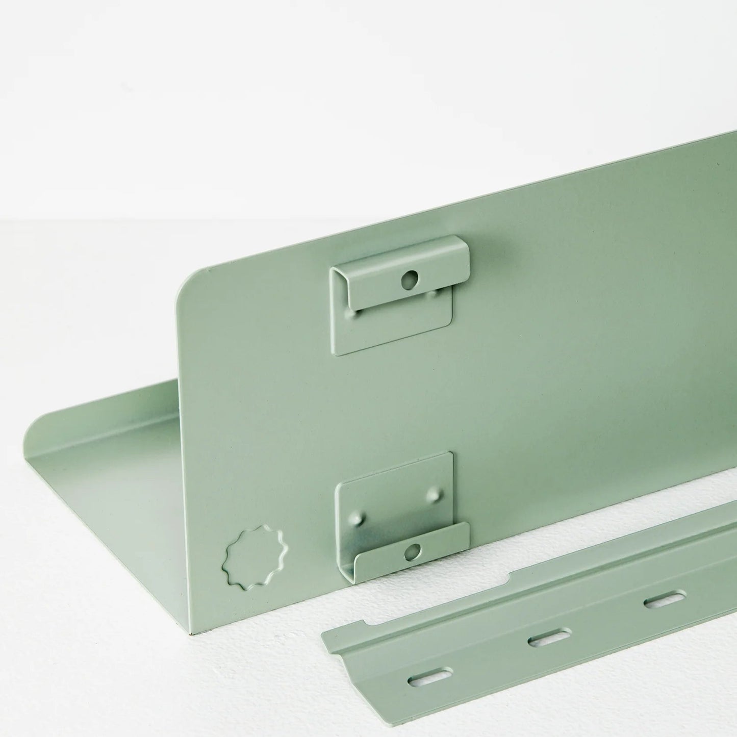 Mint green metal bracket on a white background