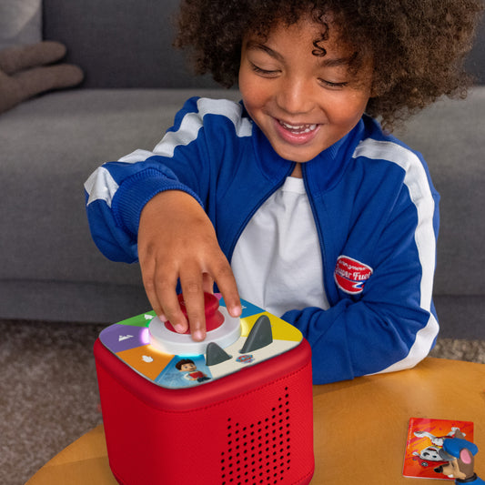 Child playing with a colorful toy on a table