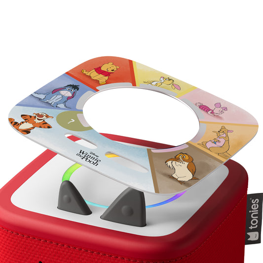 Red toy with a circular panel featuring cartoon characters on a white background