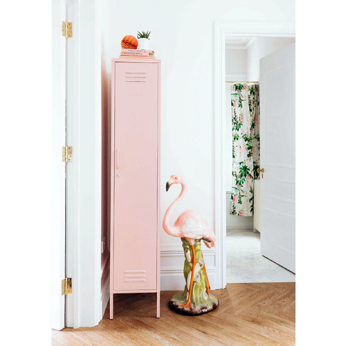 Pink locker with a flamingo design in a room with floral curtains.
