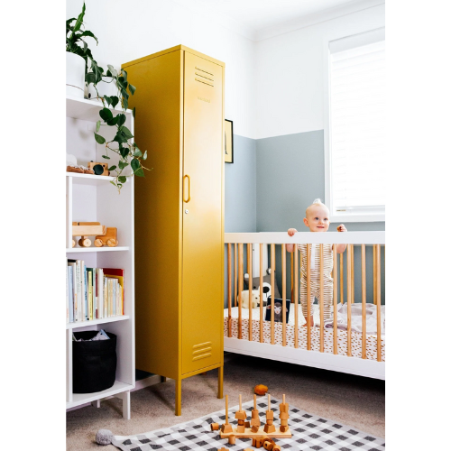 Yellow locker in a child's room with a crib and books on a shelf.