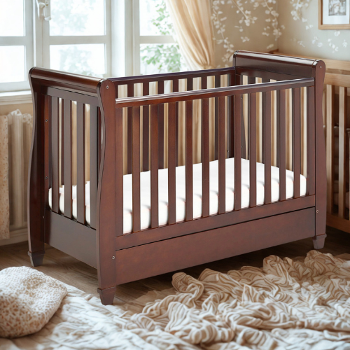 Wooden crib with white mattress in a nursery setting