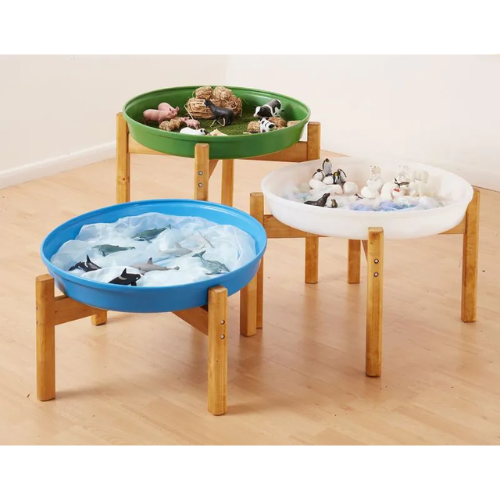 Three colorful trays with wooden stands on a light wood floor.
