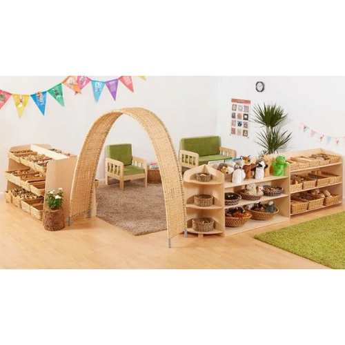 Children's playroom with wicker arch, shelves, and chairs.