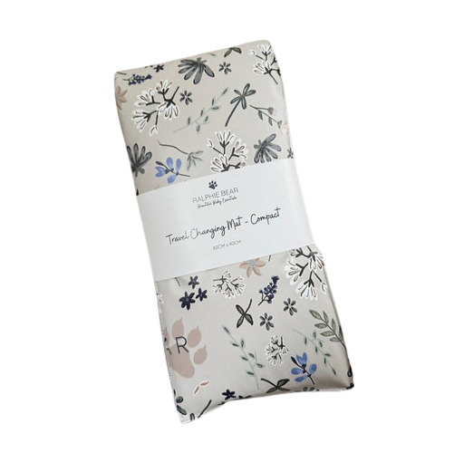 Folded floral-patterned changing mat with a visible brand label on a white background